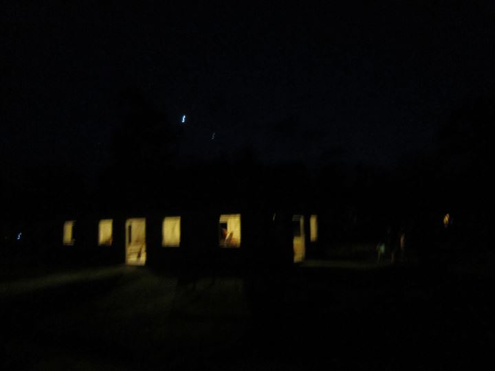 Wooden houses in the dark with lit windows